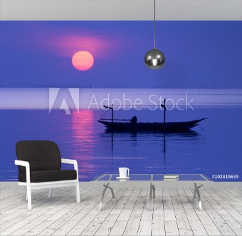 Picture of Peaceful Morning at sunrise with small boat silhouette in the beach